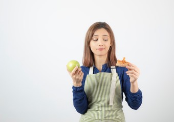 portrait-young-woman-looking-slice-pizza-apple-white-wall.jpg